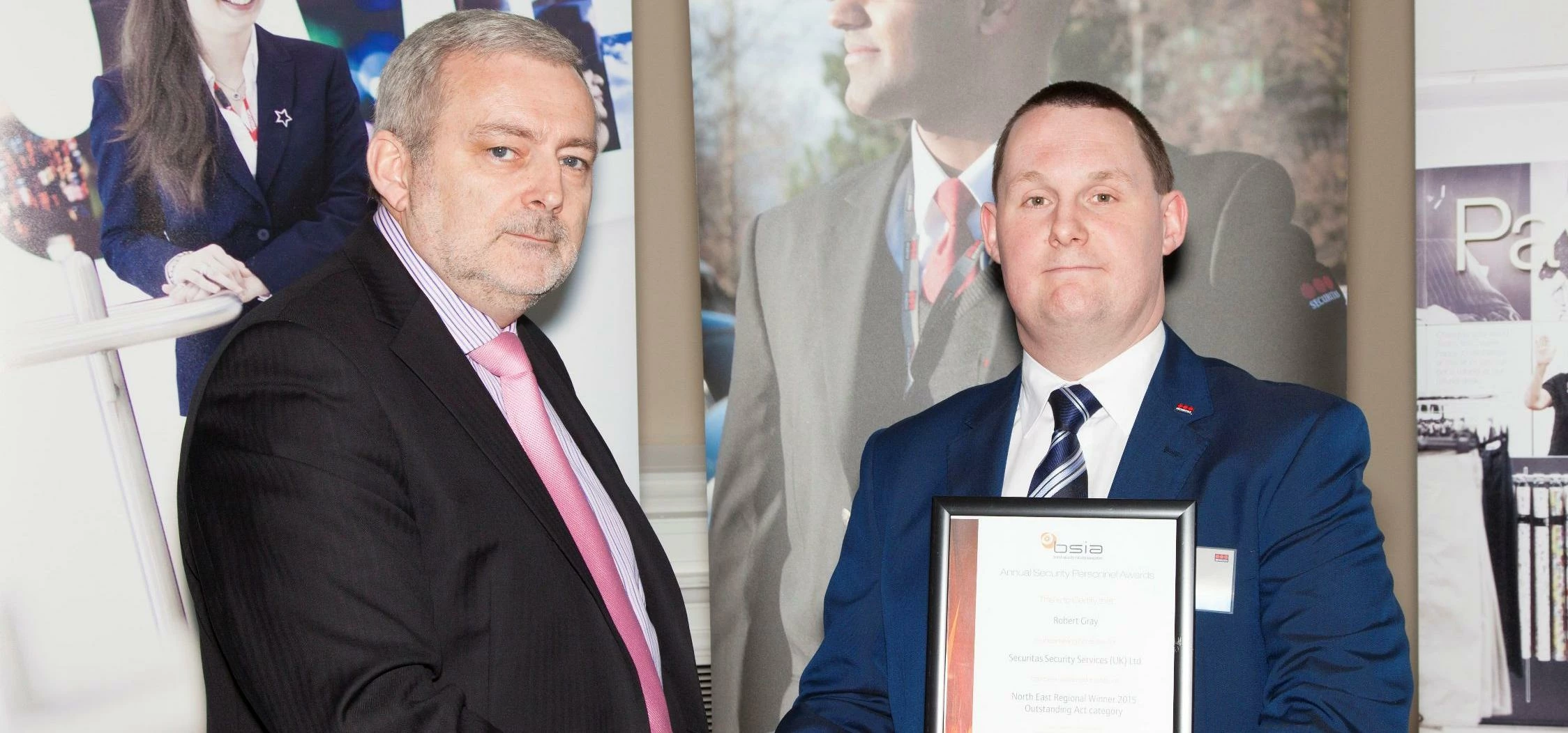 Robert (right) receives his award from BSIA Director, Trevor Elliot