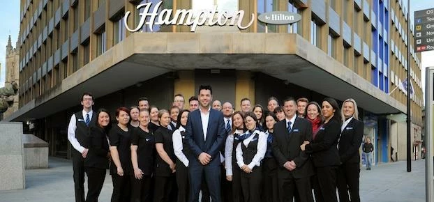 The team outside the new hotel