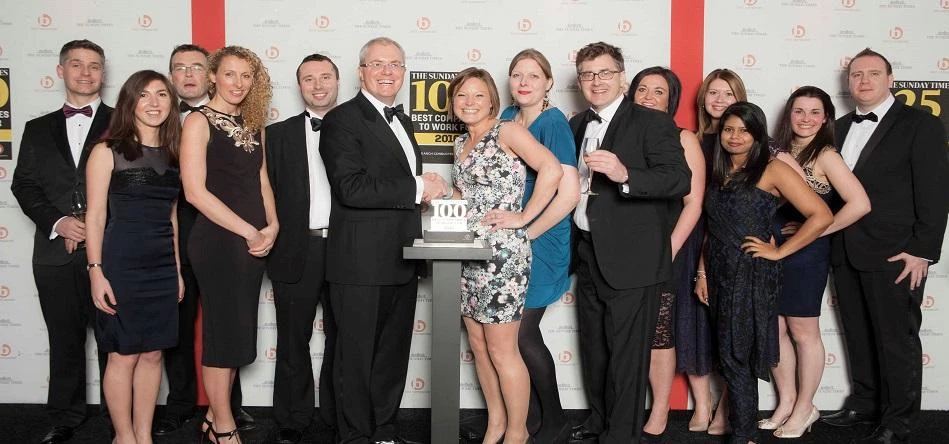 The team at Explore Learning receive their Sunday Times Best Companies to Work For Award from Jonath