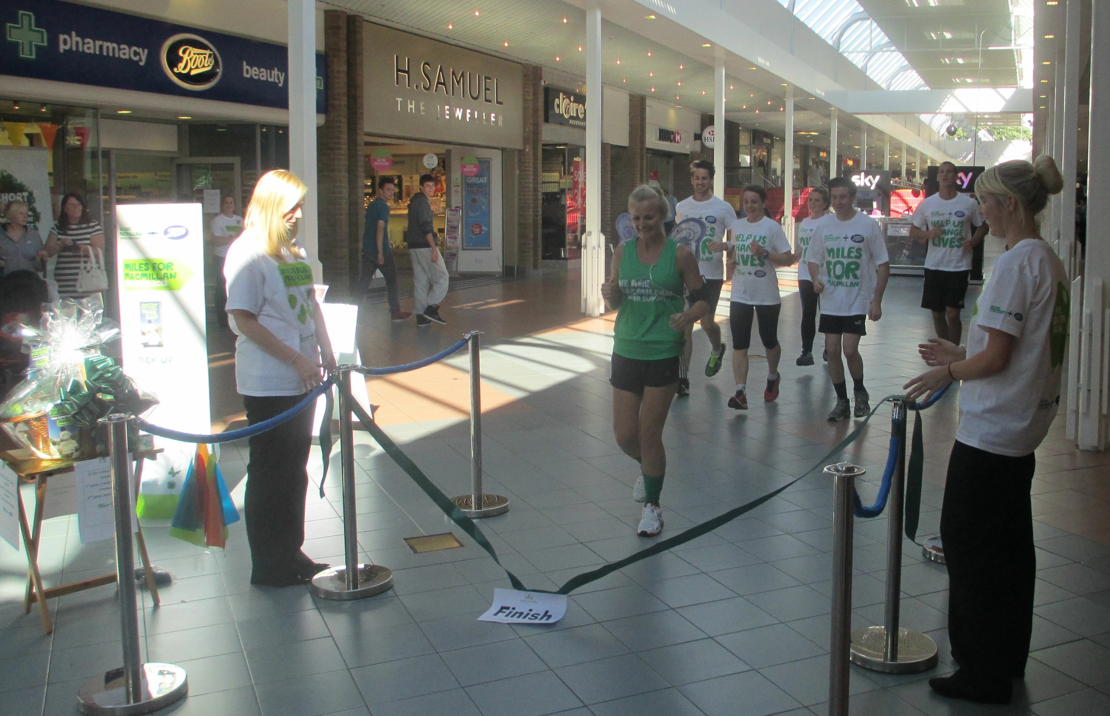 Lauren running to the finish line outside the Boots store at Manor Walks Shopping and Leisure. 