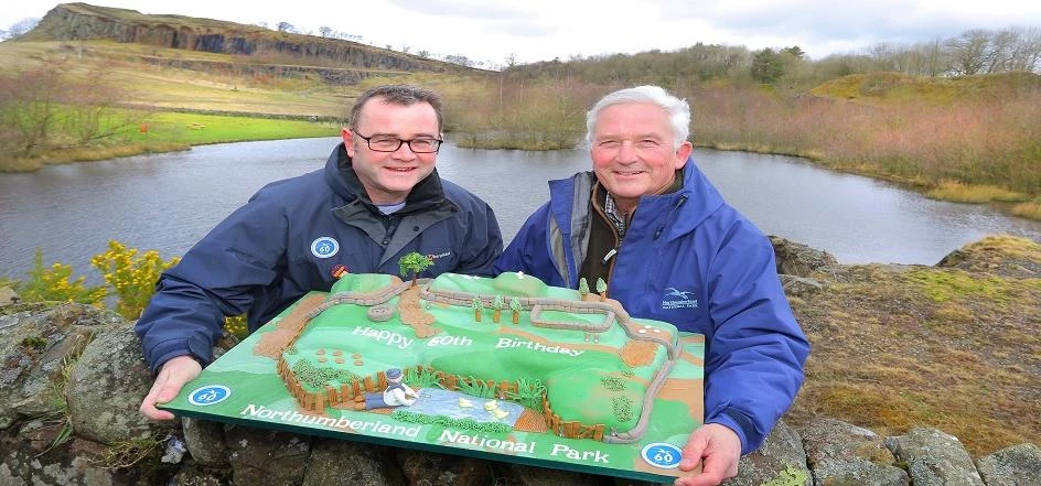 Chief executive Tony Gates (left) and chairman Glen Sanderson deliver the cake to Northumberland Nat