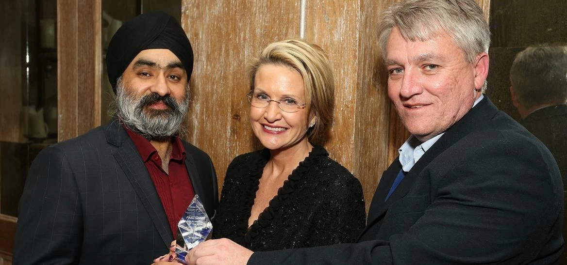 Charan Anand, owner of FASTSIGNS Watford (left) receives 3rd place in the Sales Achievement Award fr