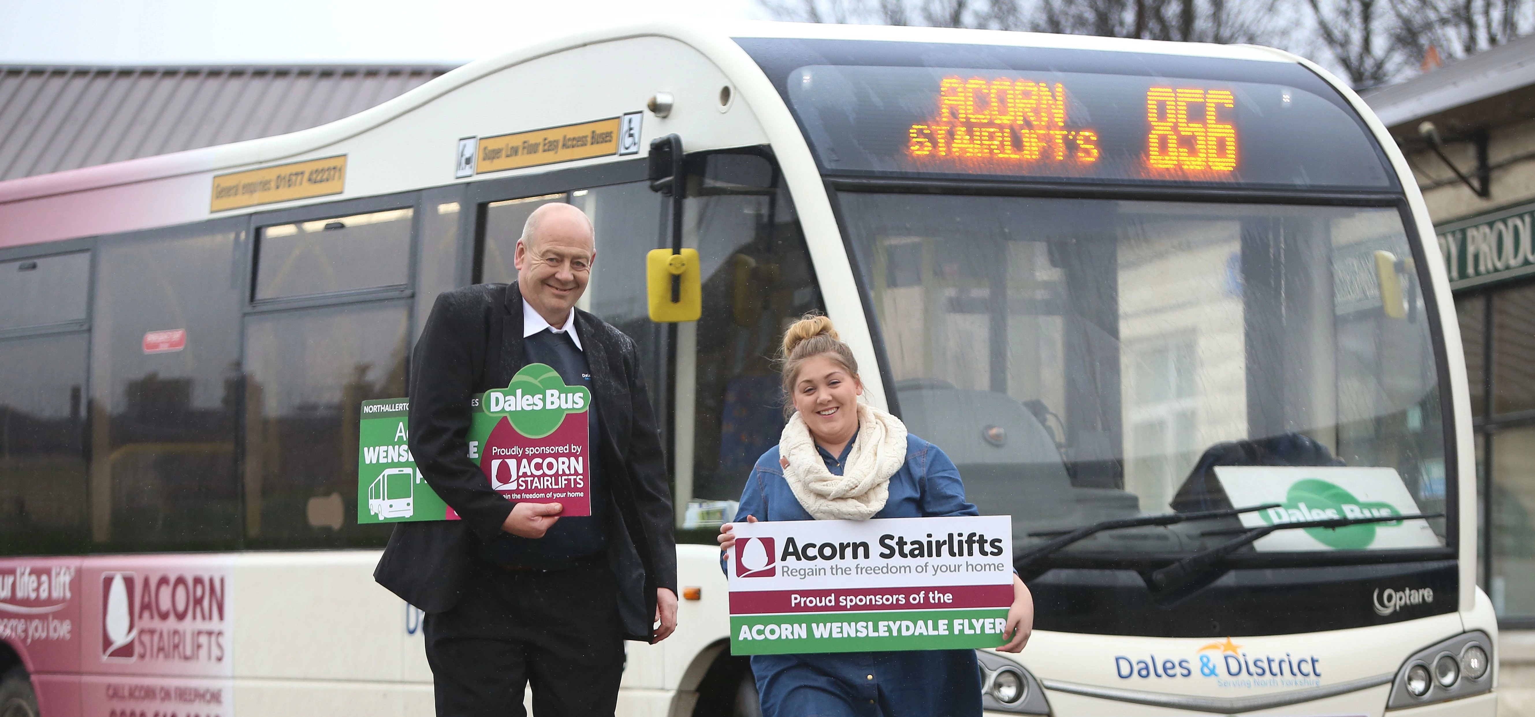 Bus driver John Harker and Acorn Stairlifts representative Jodie McAlister celebrating the secured f