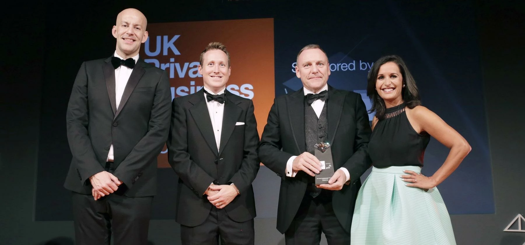 Anesco CEO Kevin Mouatt (third from left) receives the award 