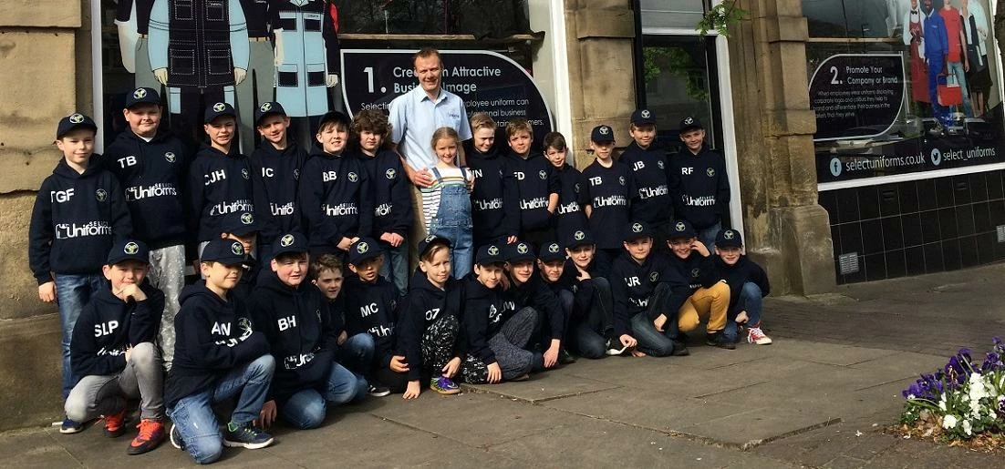 Chris Gaunt and daughter Eve welcome Aireborough RUFC juniors to the Select Uniforms showroom in Raw