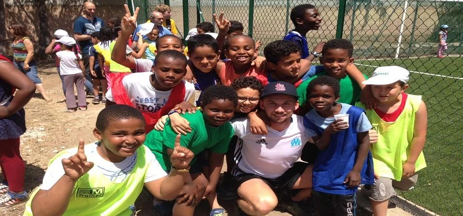 Marco with local children who will benefit from the new community football pitch.