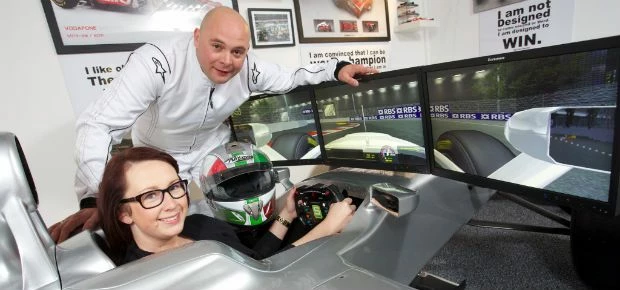 Jenni Seymour RBS and Gareth Stone MD of Stonerig Raceway try out the new F1 Simulator (1024x683)