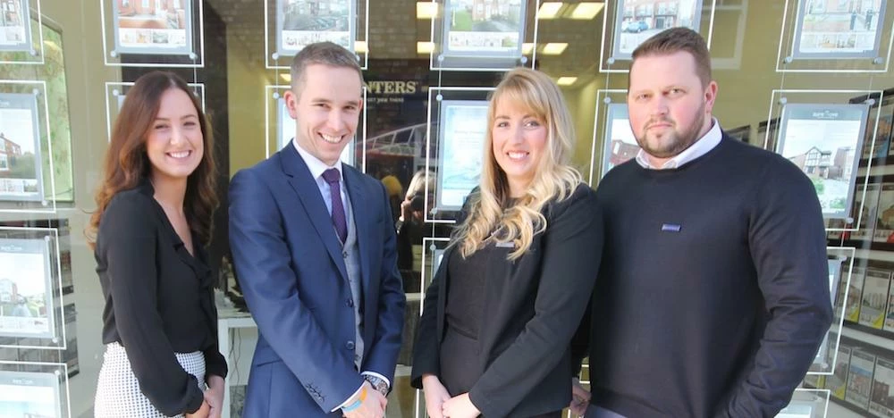 Hunters franchise owner Lee Andrews (second left) with the team outside the St Helens branch