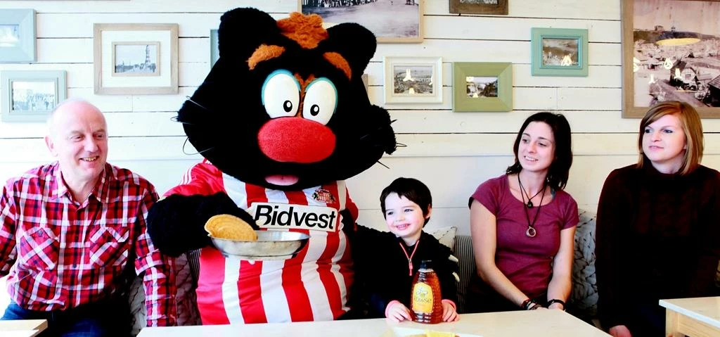 SAFC mascot Samson tossing pancakes at the Beach House