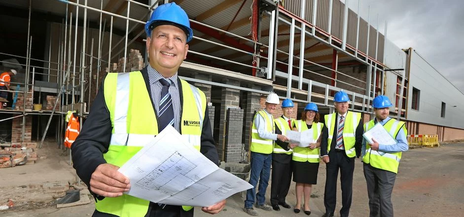 Charles Clinkard, managing director of the family footwear firm, watches work progress at the compan