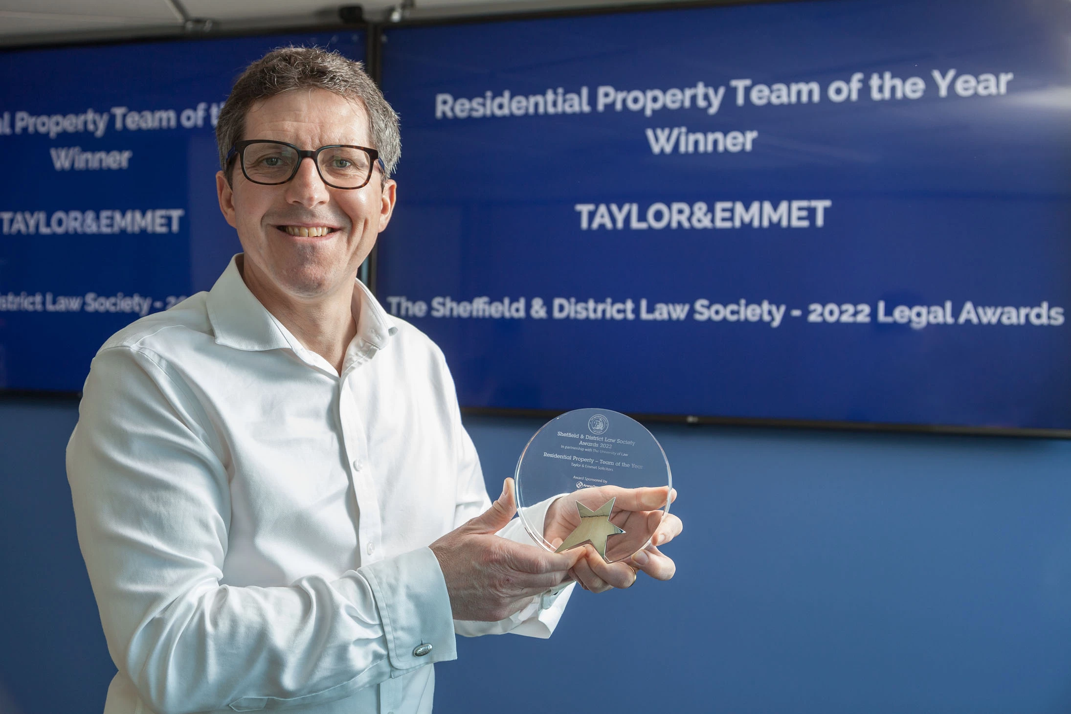 Neil Riley, Taylor&Emmet's head of residential property, with the award presented to his team by Sheffield and District Law Society. 