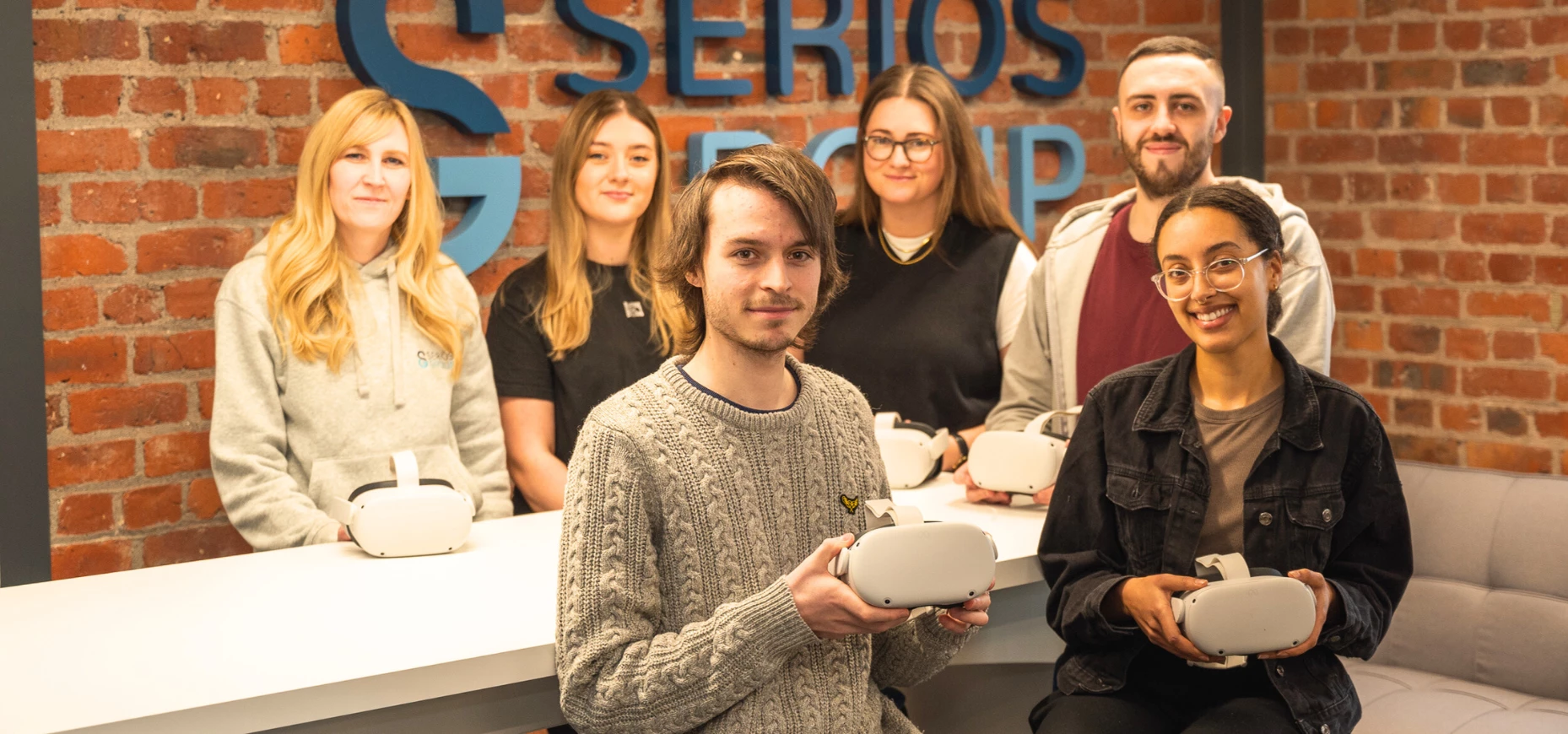 Members of the Seriös Group team receiving their new virtual reality headsets.