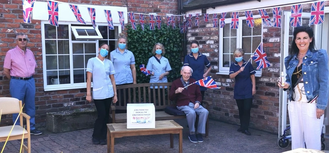 Qualkem Brands Director Rachael Anketell-Clifford (right of pic, with her 99-year-old grandad George Frazer, her dad and company founder Robert Frazer and staff at the Parkhouse Care Home and Mews, Sandbach.