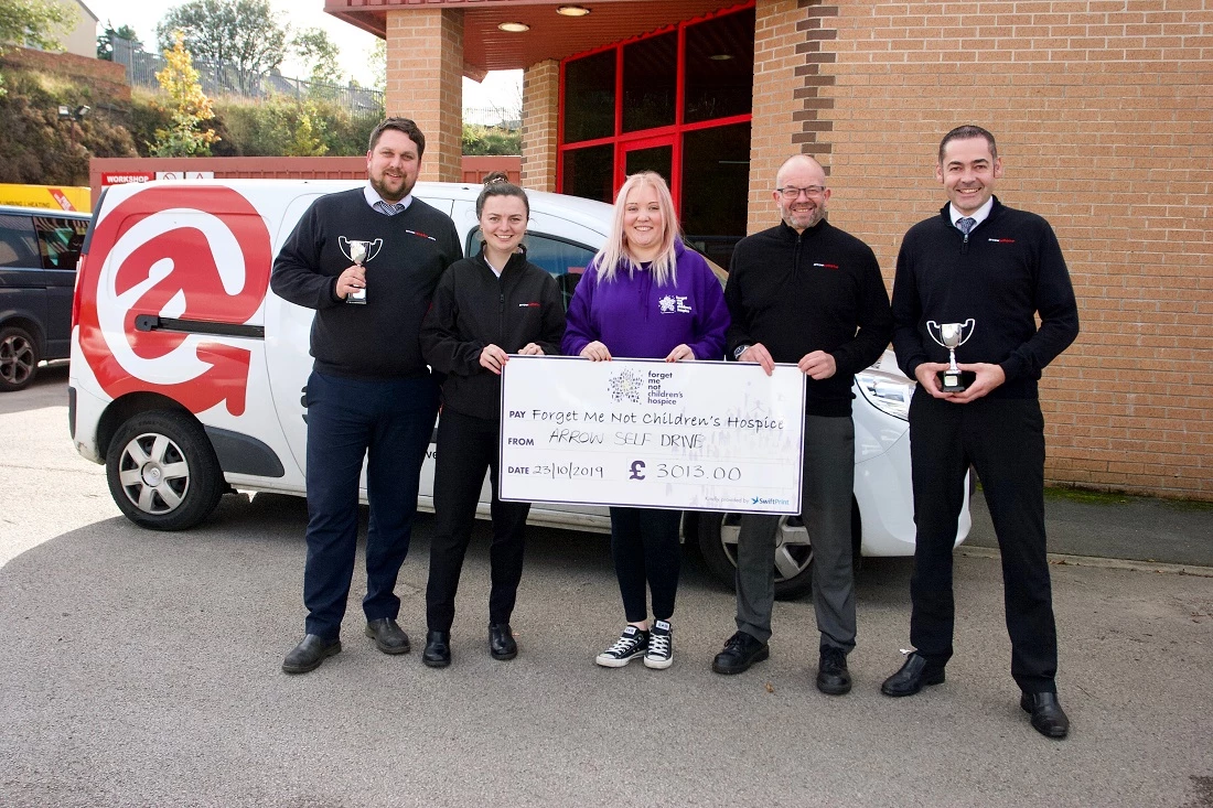Arrow Self Drive team with trophies and cheque for Forget Me Not Children's Hospice