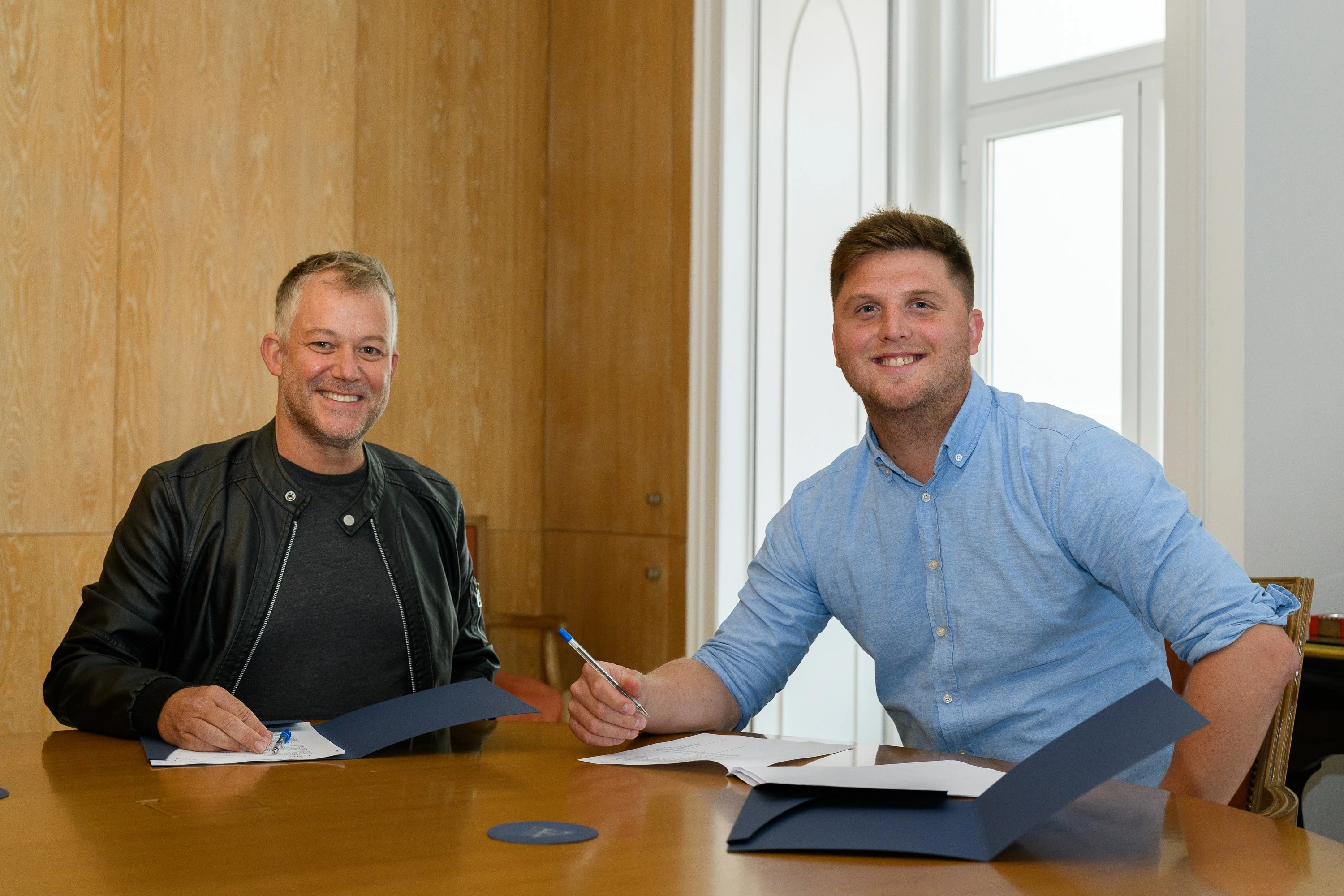 Dave Williams NomadX Founder (left) and Radim Rezek (right) signing the merger