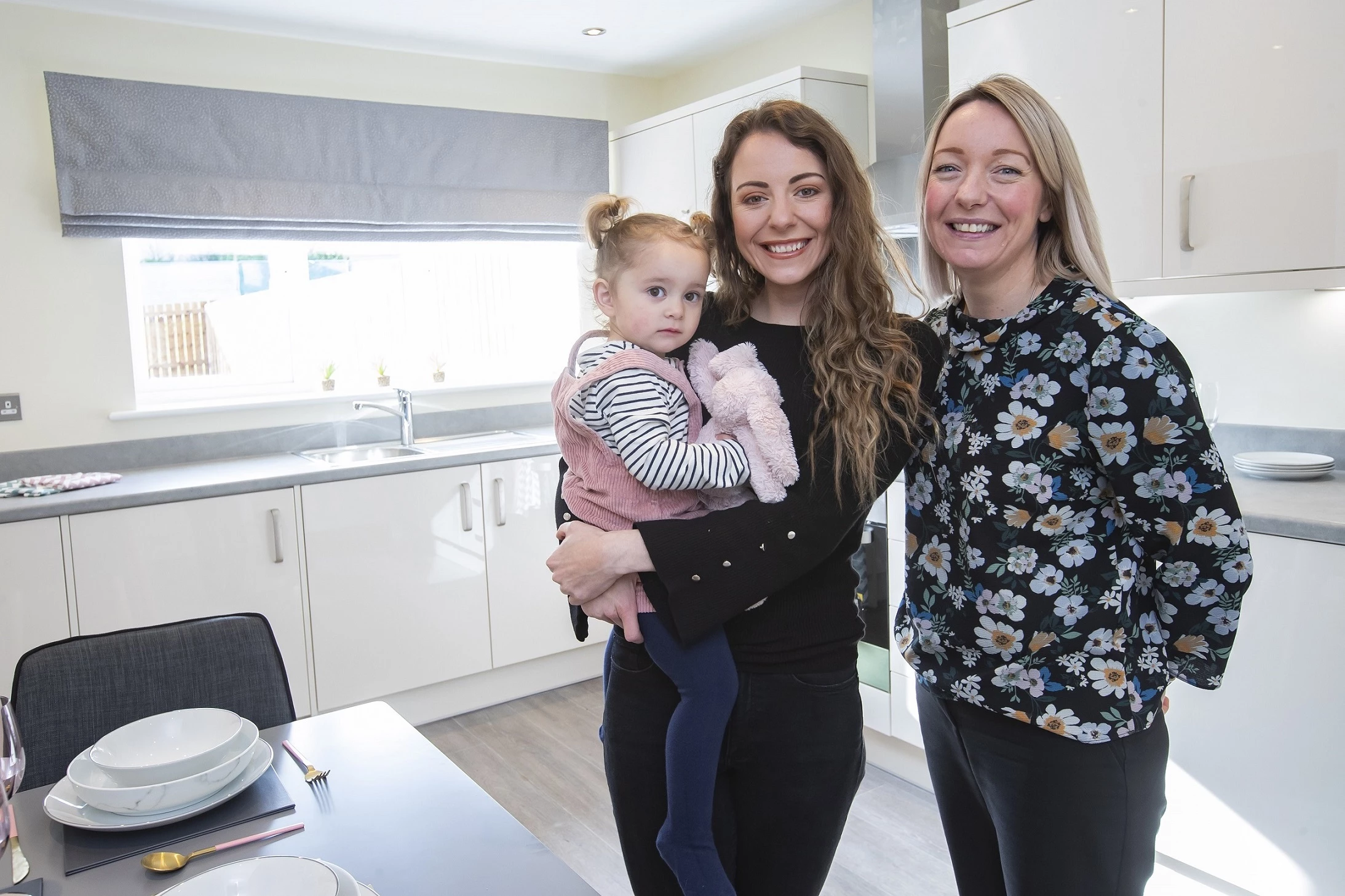 L-R Happy customer Danielle Huntingdon and her daughter Mila with Rebecca Marshall, development project manager at m!ne housing.