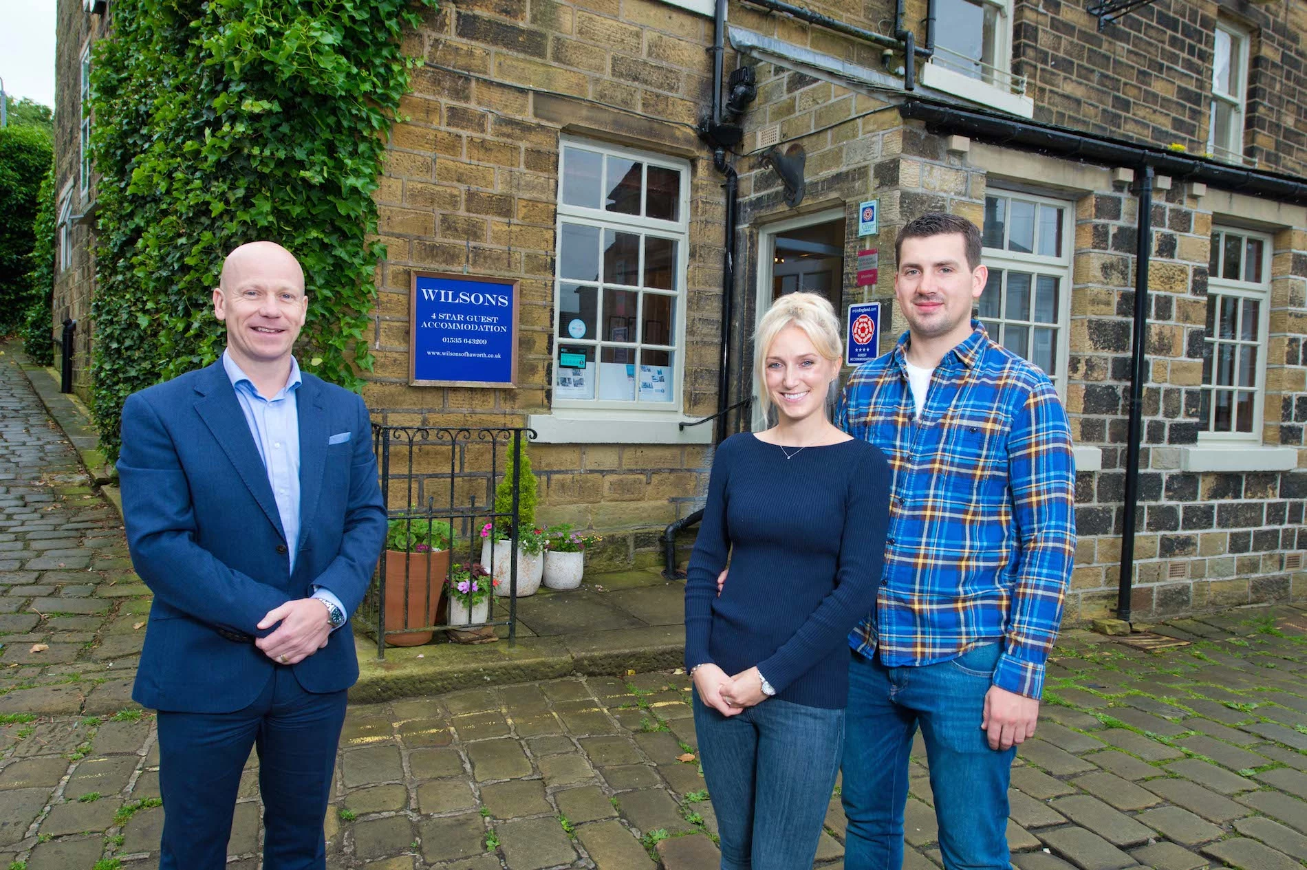 Andrew Matley (Royal Bank of Scotland) and new owners of Wilsons of Haworth, Josie Price and Brendan Sutherland.