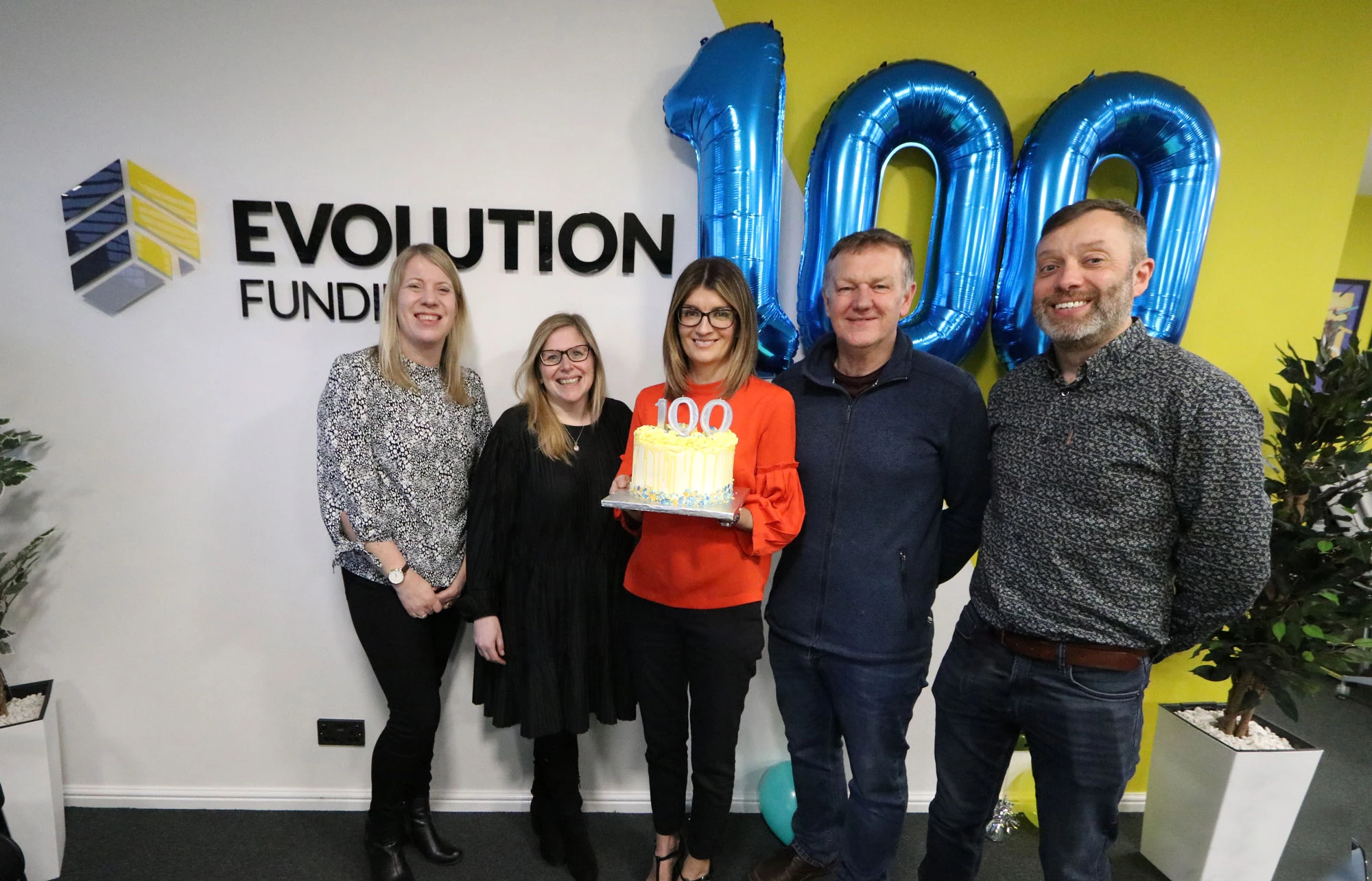 Evolution Funding staff celebrating £100 million advances milestone