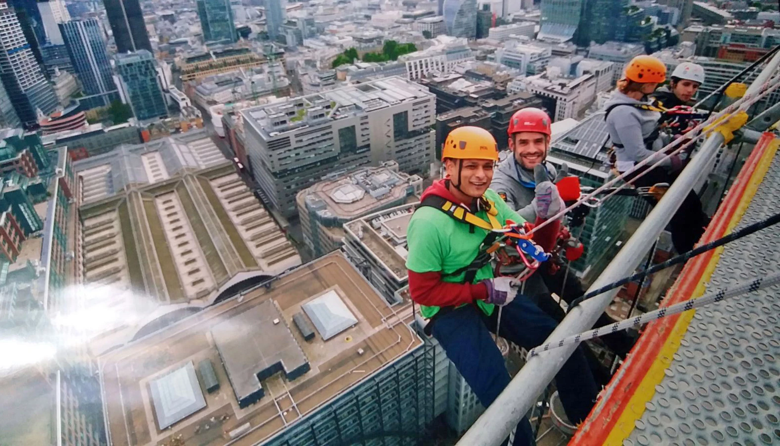 Ryan Dent (far left) Manager at Flip Out London E6 begins his 540ft abseil attempt for Richard House