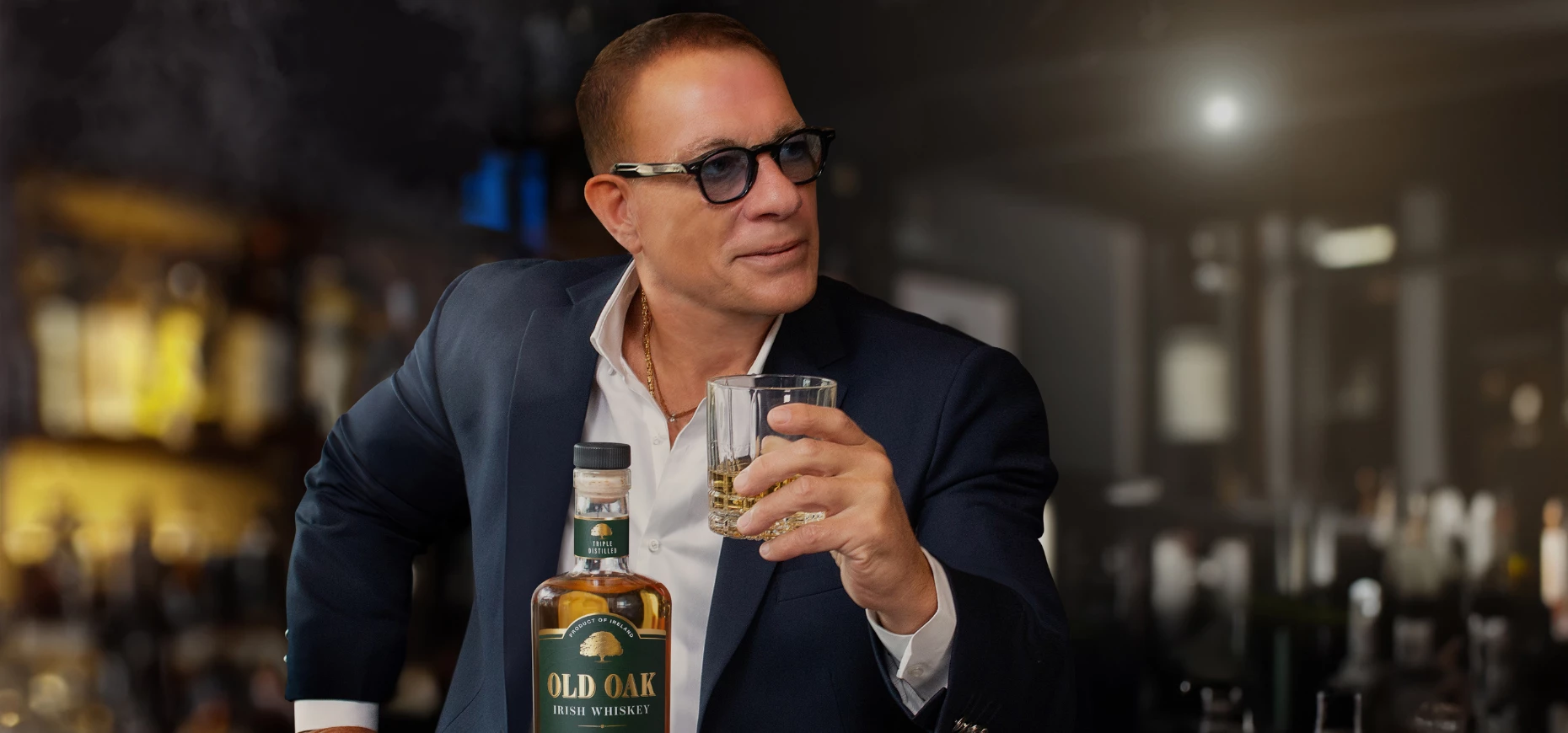 Jean-Claude Van Damme sat with a glass of his new Irish Whiskey, Old Oak.