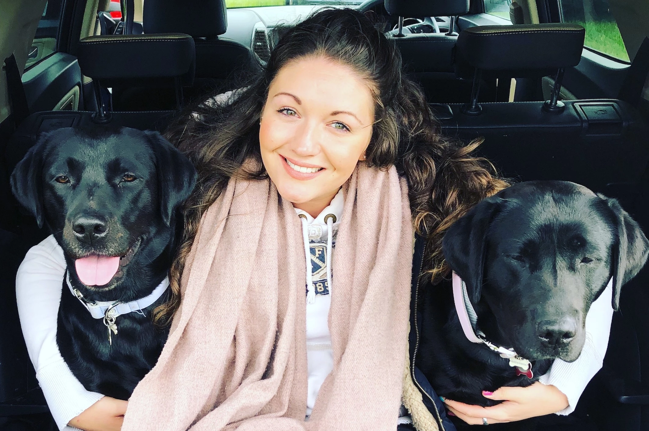 Founder of Olive & Berry, Natalie Tyson, with her two black labradors who inspired the business