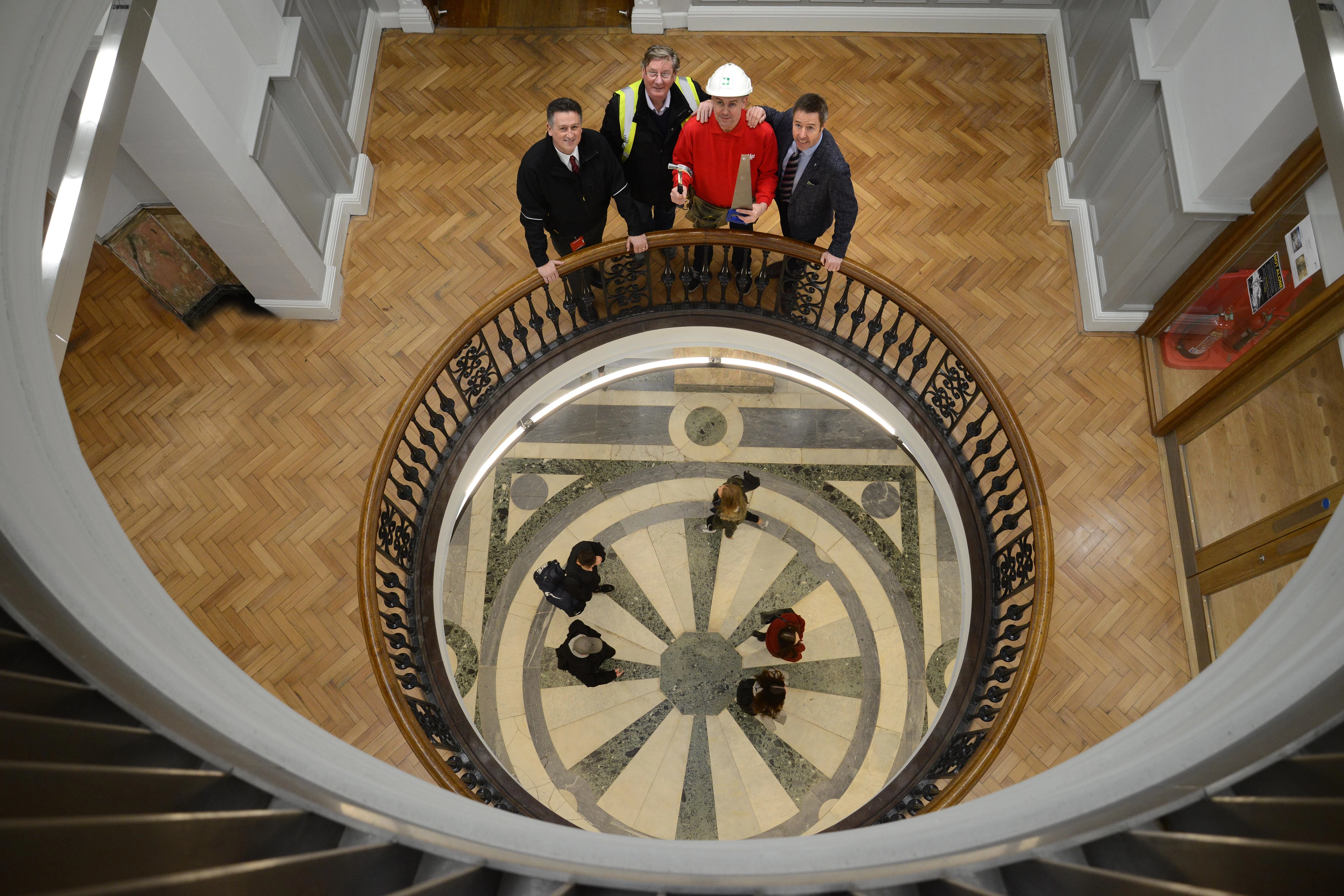 Steve Todd (in hard hat), with Phil Burridge (right), Stephen Pyle (left) and Site Manager Russel Smith on the refurbished spiral staircase area of the Armstrong Building.  