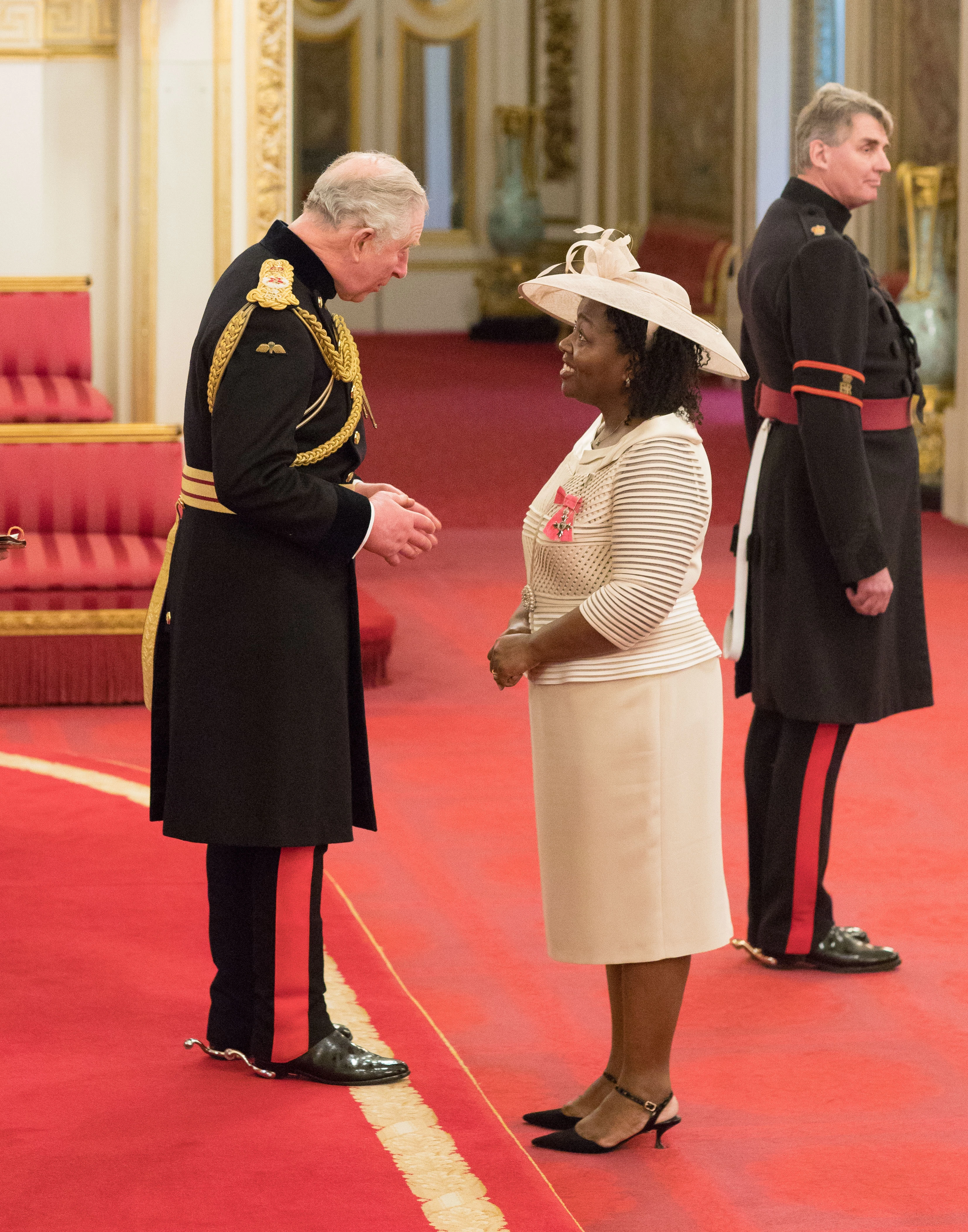 Olive Strachan receiving her MBE from HRH Prince Charles at Buckingham Palace