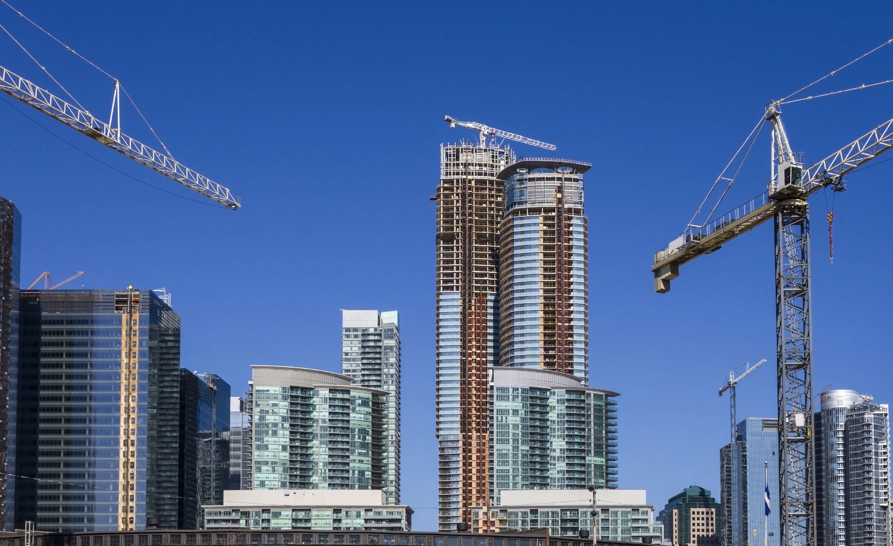 Tall buildings with cranes