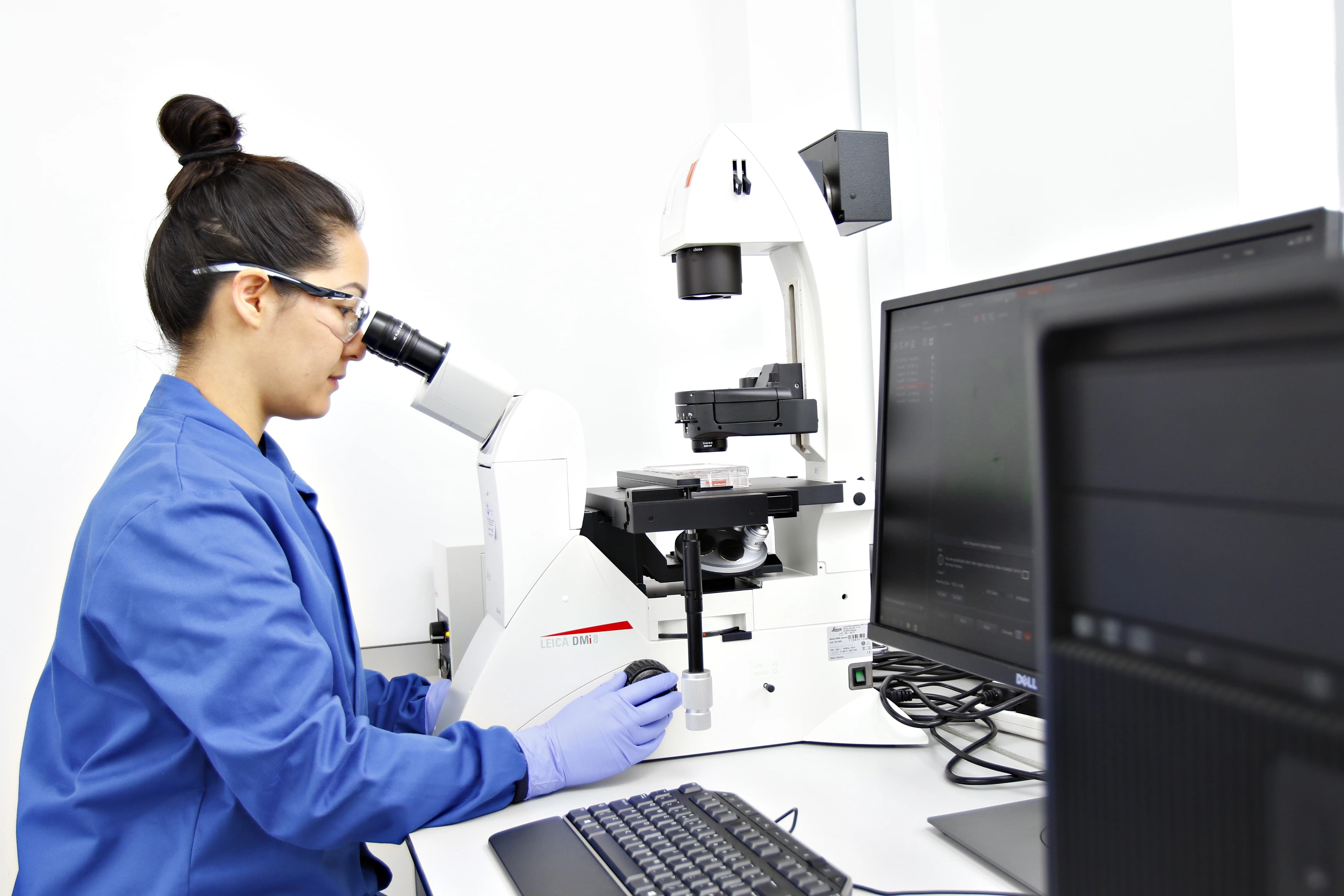 A REPROCELL scientist analyzing microscopy results in one of the company’s stem cell laboratories.