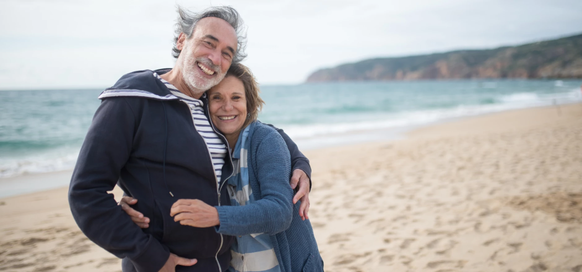 retired couple on beach.png