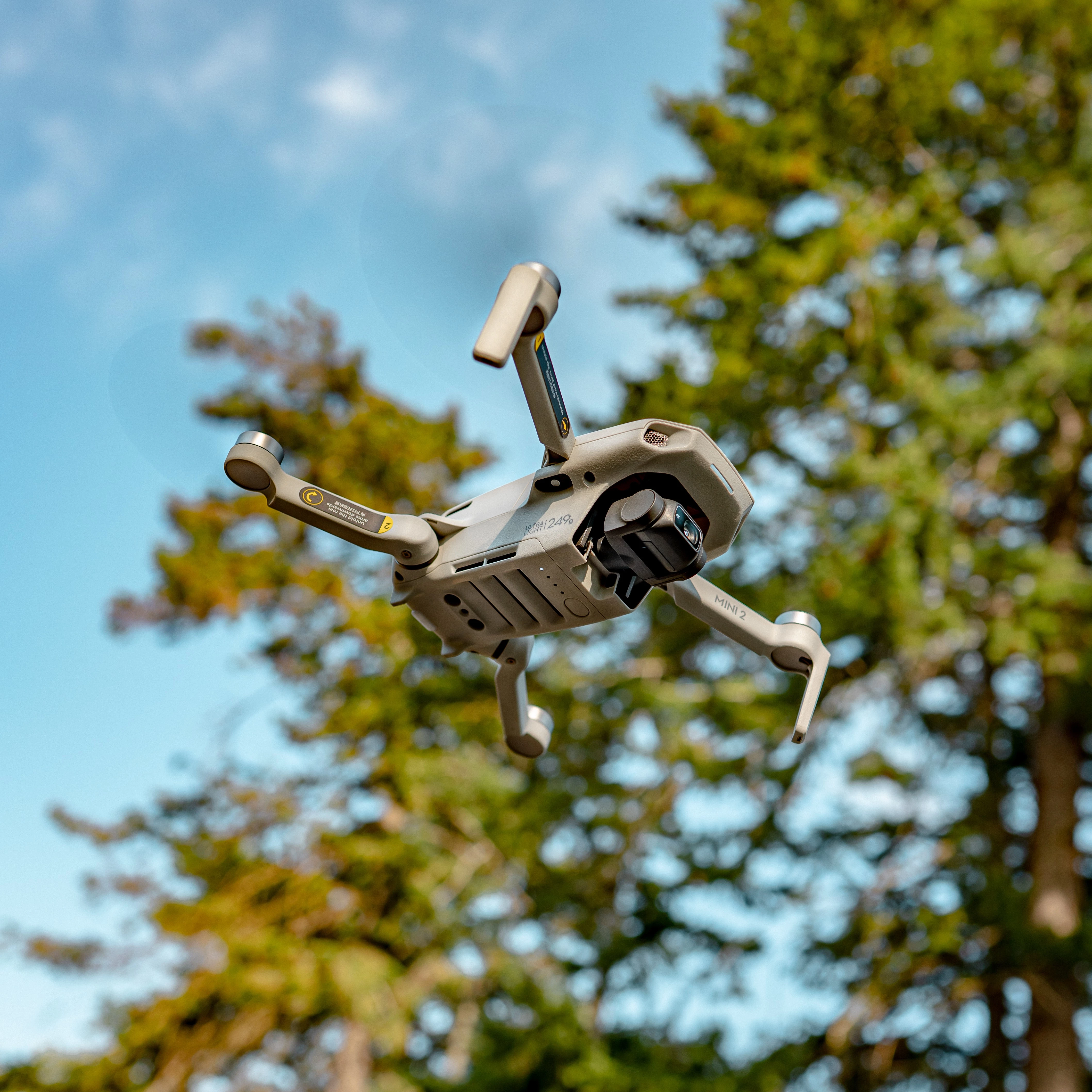 A drone flying in an area of woodland