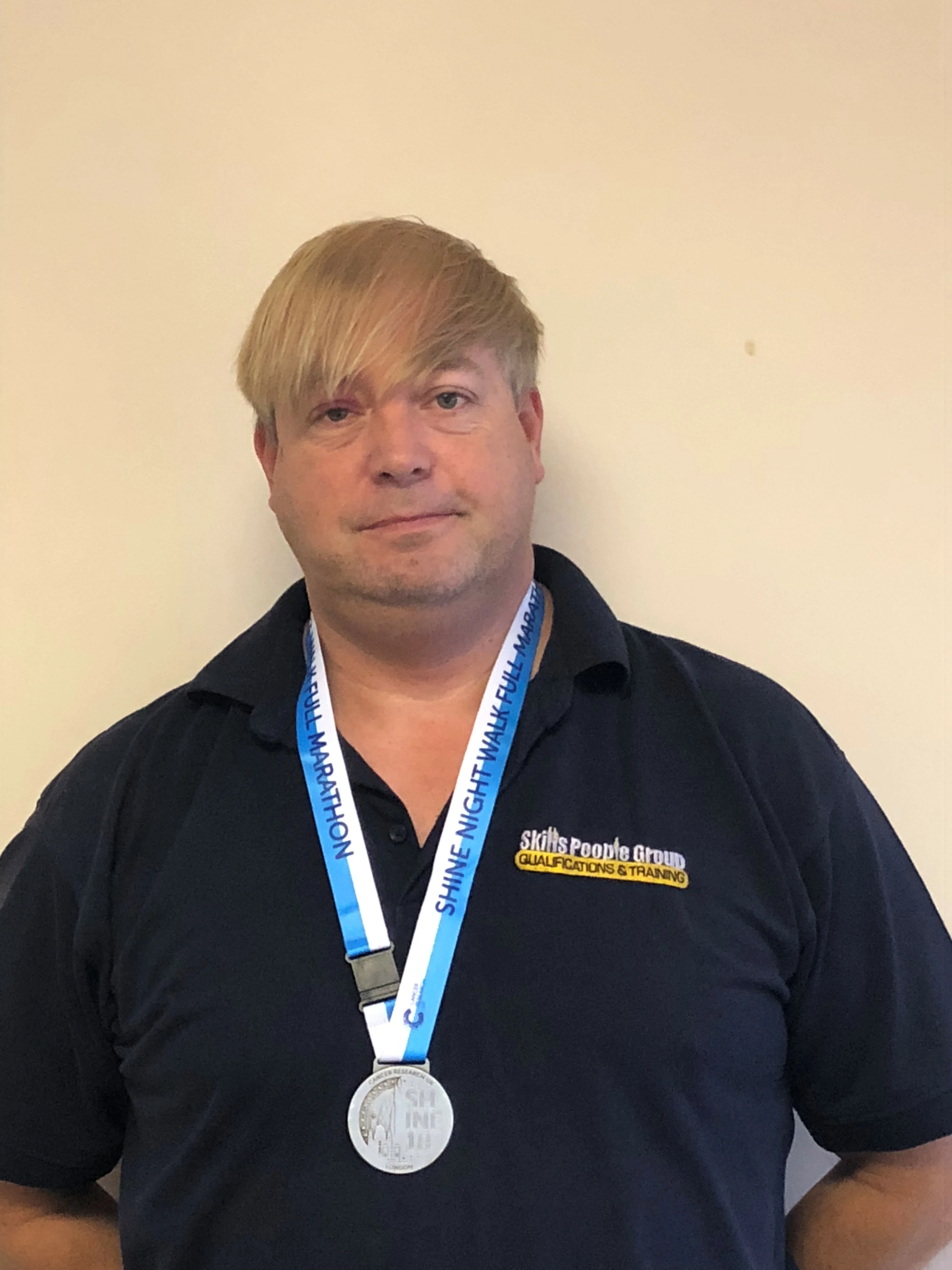 Construction Skills People’s Stuart Brown with his medal having completed the Shine Night Walk London to raise funds for Cancer Research UK.