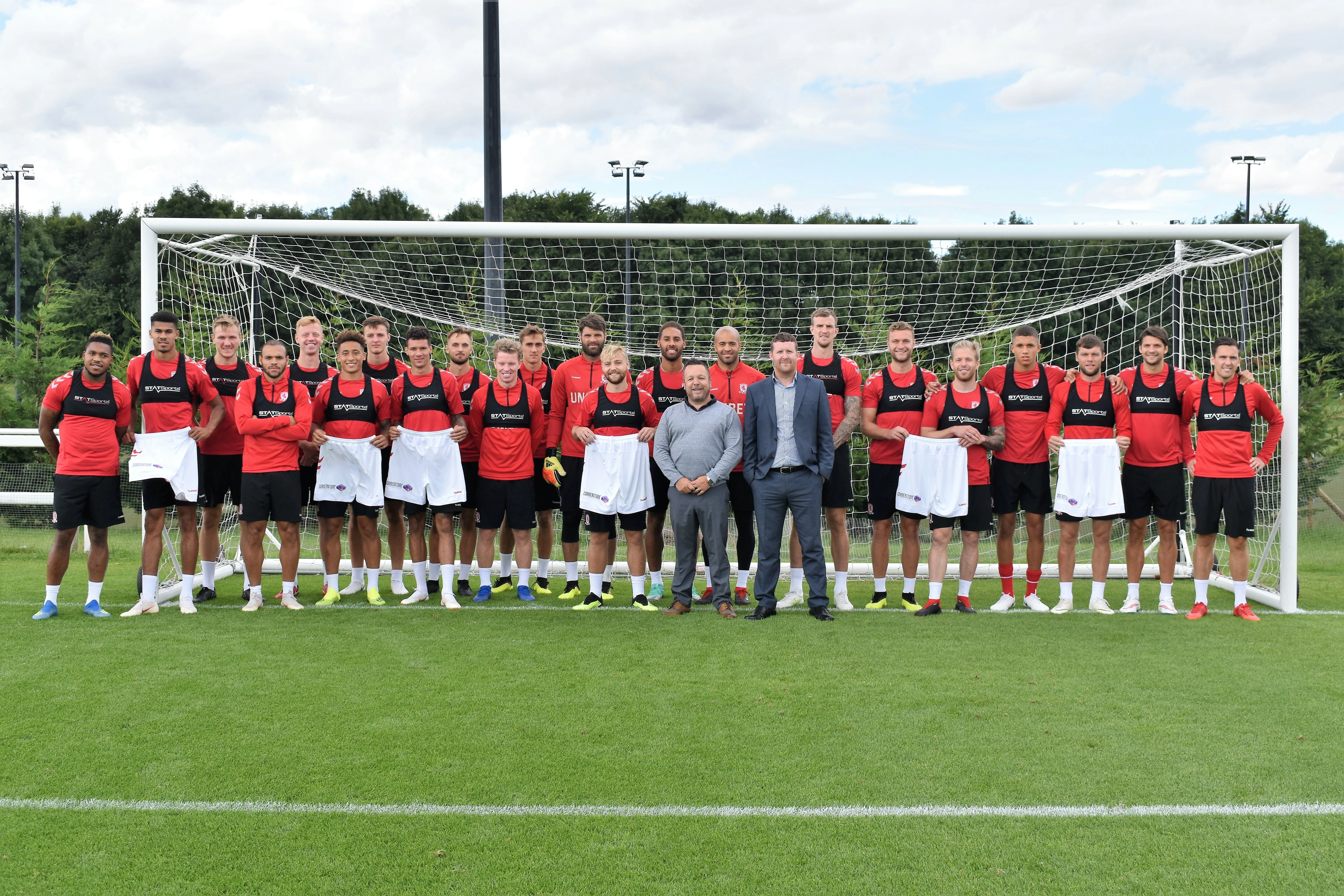 Middlesbrough’s first team squad with Cornerstone Business Solutions directors Chris Petty and Chris Bibby at the club’s Rockliffe Park training HQ.