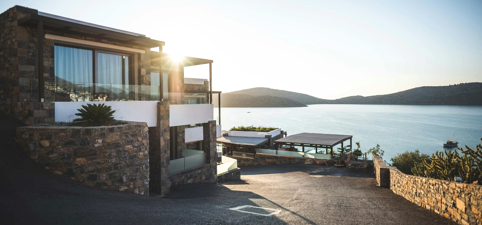 Sun Piercing of Brown Concrete House Near Sea