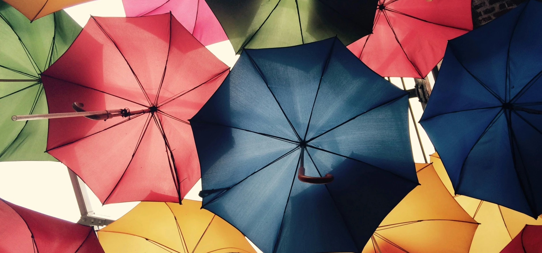 Vibrant umbrellas create a colorful canopy in Greater London, offering protection from sun and rain.