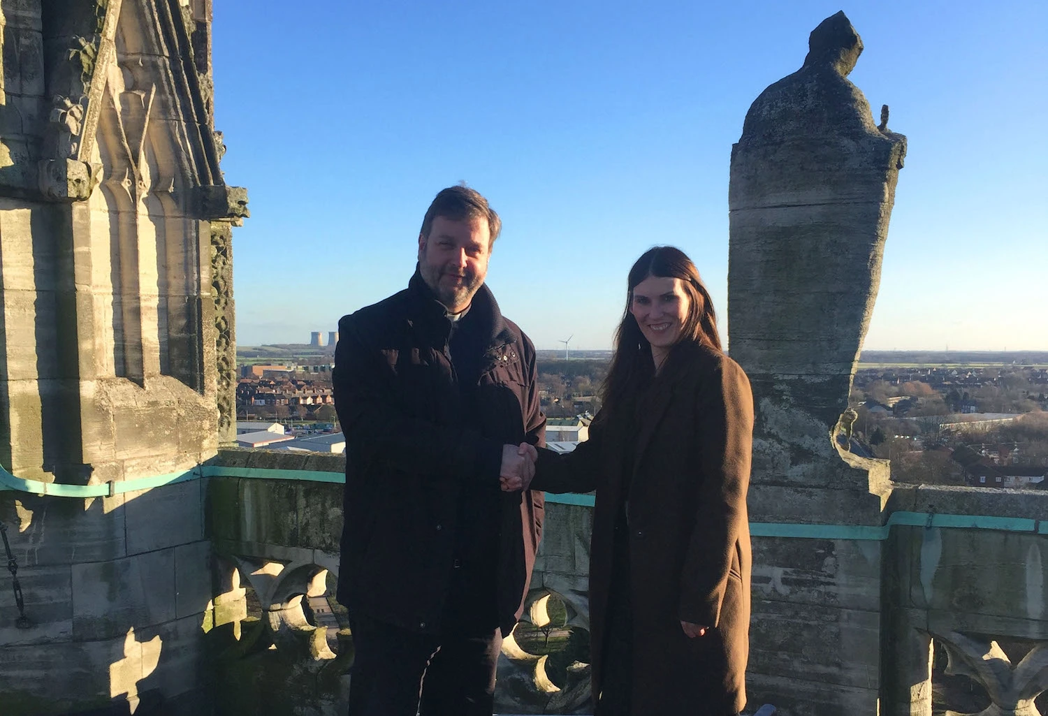 Vicar of Selby Abbey, The Reverend Canon John Weetman with Hayley Silvester, Head of Sales, Quickline, on top of Selby Abbey