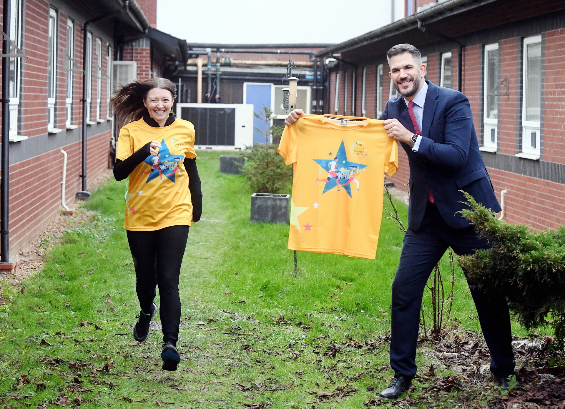 The Wigley Group's Laura Liggins - who is running for SWFT Charity - alongside South Warwickshire University NHS Foundation Trust MD Adam Carson at the site of the planned sensory garden at Warwick Hospital