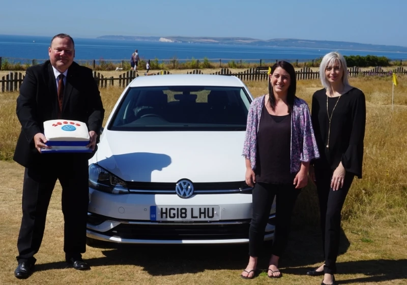 Martin Pye and Jennie Mitchell recreate a 2004 photograph with Café Riva owner, Becky Green as they sold their 20,000 vehicle.