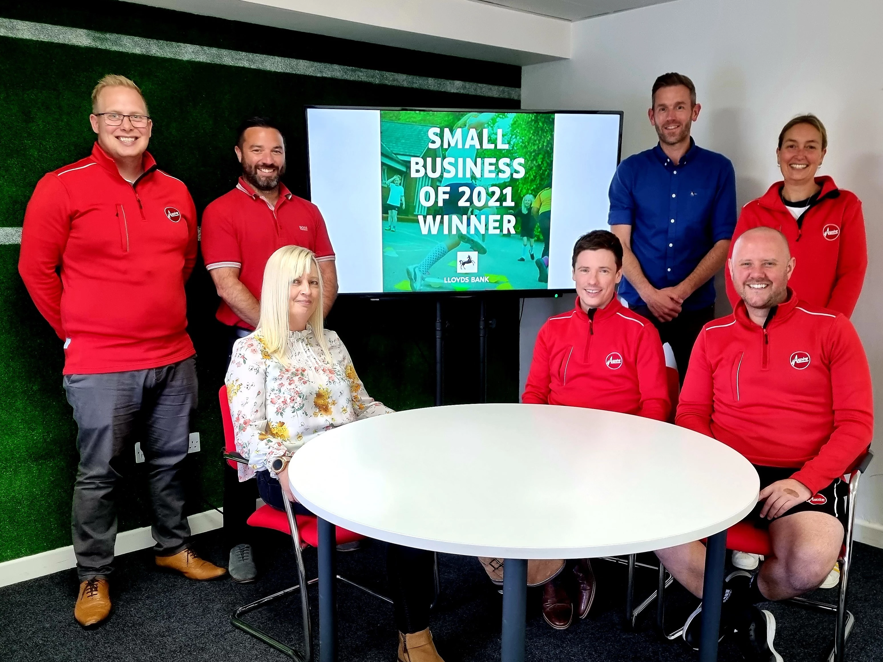 Aspire founders James Trowman (back second left) and Paul Griffiths (back second right) celebrate the Lloyds Bank Small Business of 2021 award win with the team
