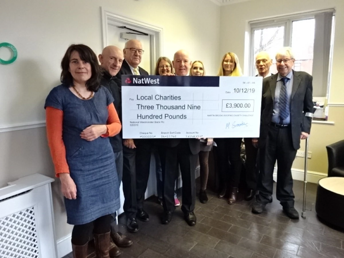 Martin-Brooks directors, Gerald Brooks (third left) and Jeremy Martin (centre) with representatives from the charities the firm supports. 