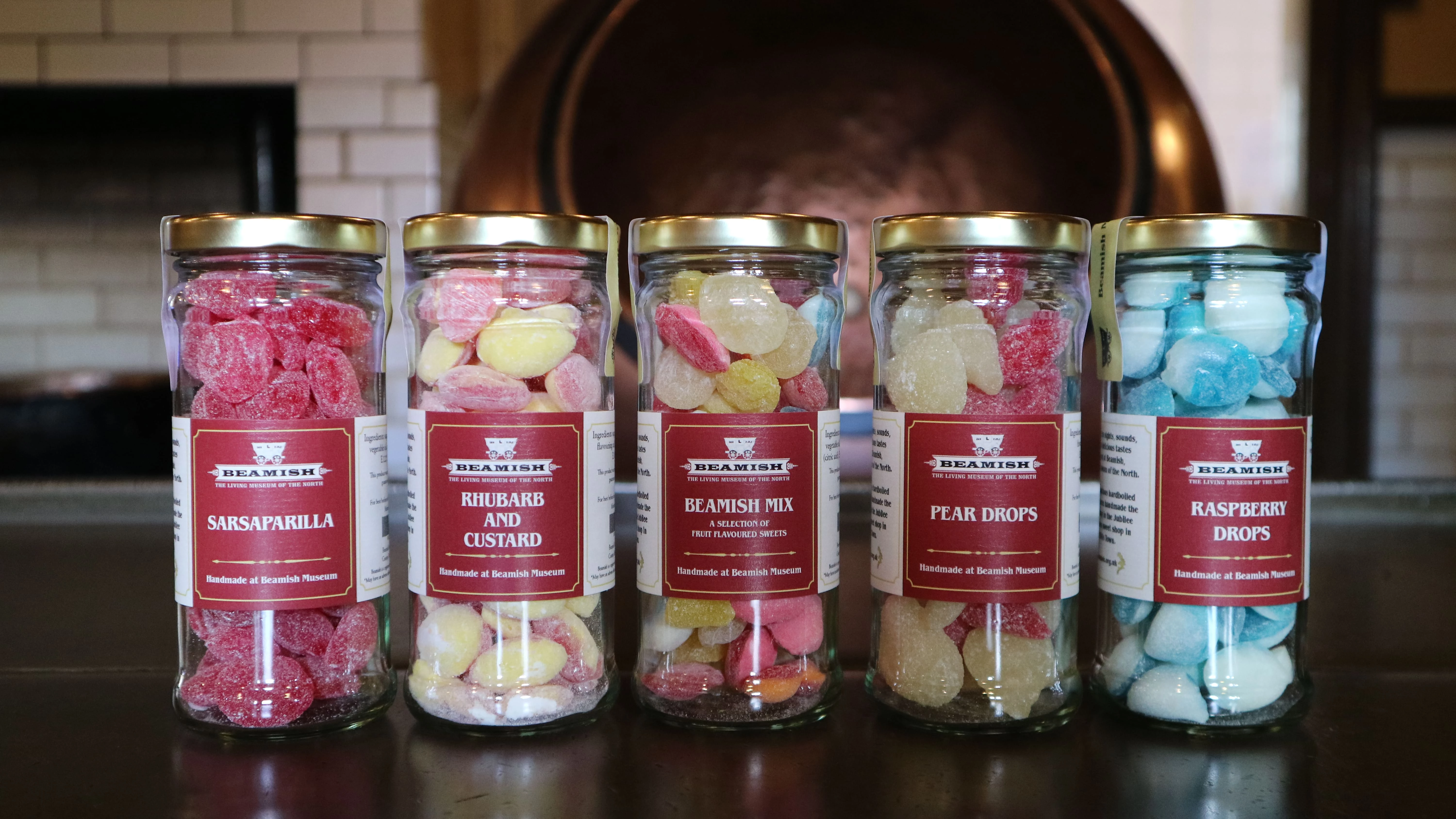 Wholesale Sweets from Beamish Museum. Image contains five jars of hard boiled sweets with locally-printed Beamish Museum branded labelling, inspired by the Beamish collections.