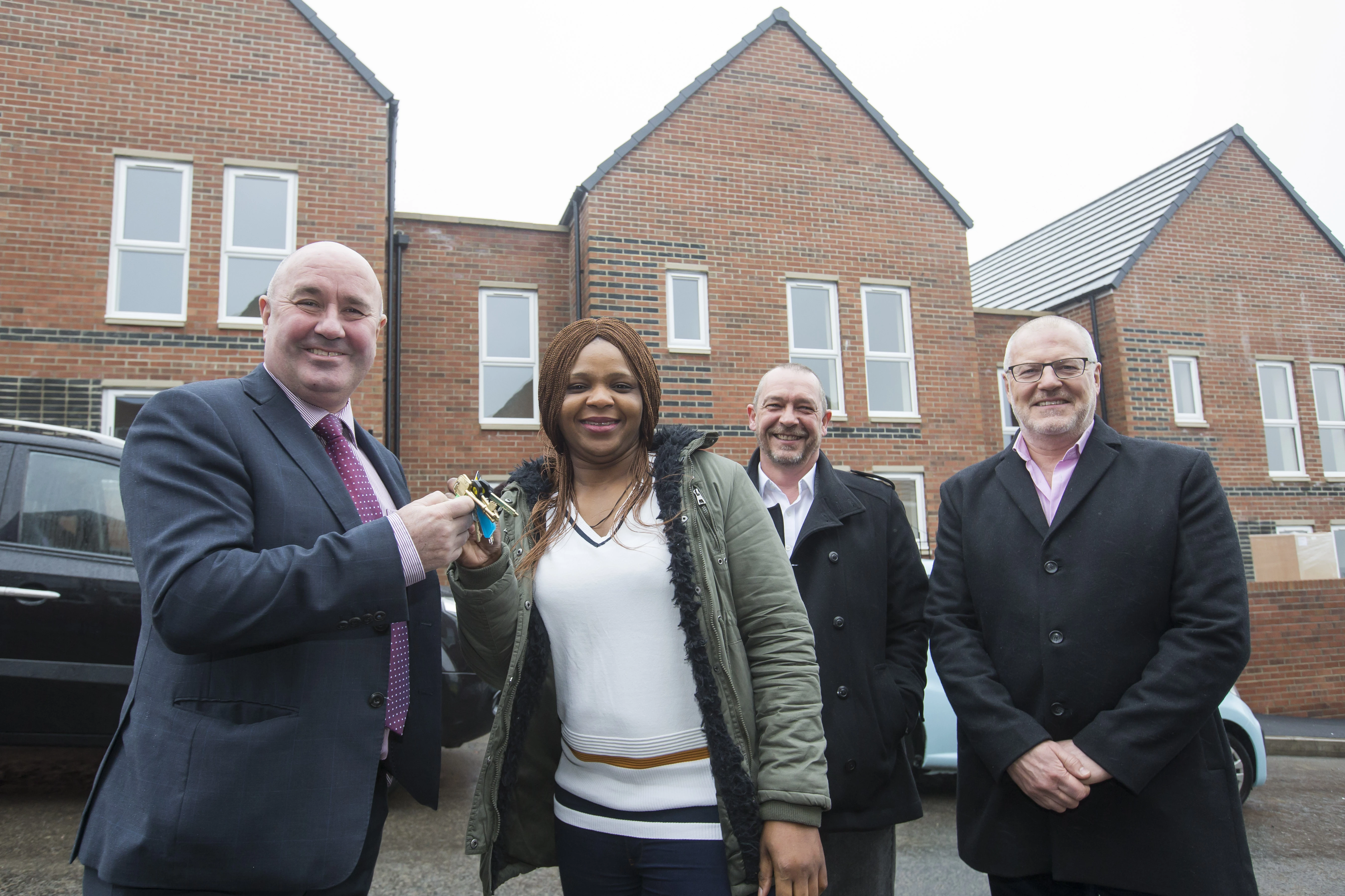 Cllr Ged Bell handing Toju Ekpe the keys to her new home, alongside Mike Clark, development director, Tynexe, and Brian Ham, executive director – development, Home Group 