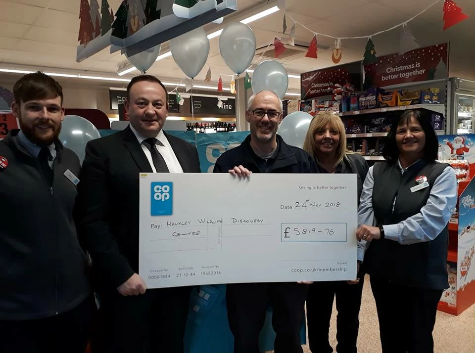Staff from the Co-op food and Funeralcare store in Amble present a cheque to Northumberland Wildlife Trust’s Duncan Hutt (centre).  
