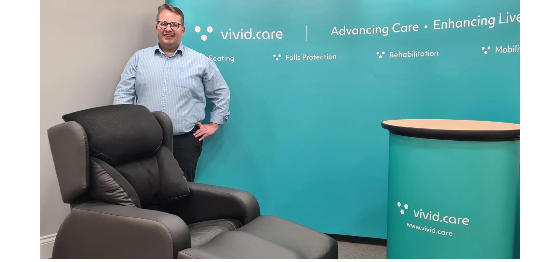 Graham Oliver Commercial Director at Vivid Care stands behind the Lento Neuro medical disability management recliner chair