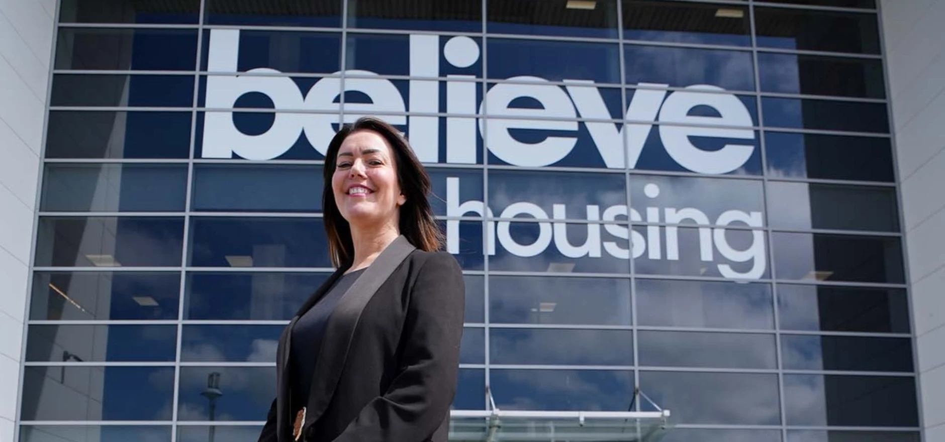 amy mooney board member at believe housing outside office.JPG