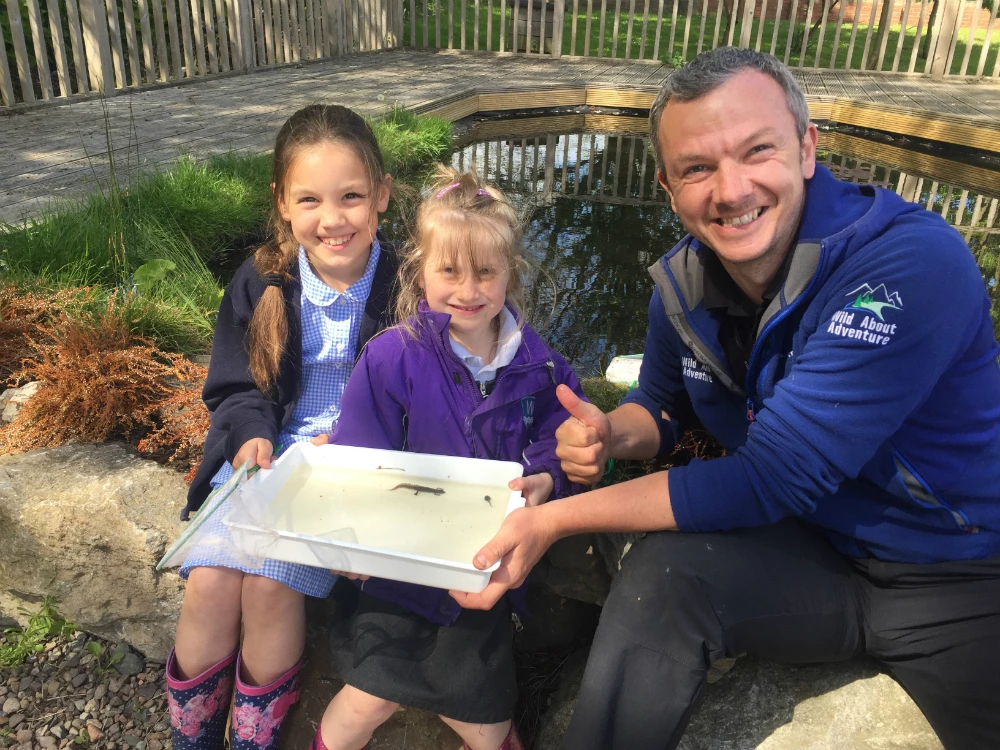 Bothal Primary School pupils, Poppy Dawson and Grace Appleby with Paul Mordue from Wild About Adventure at the new pond.