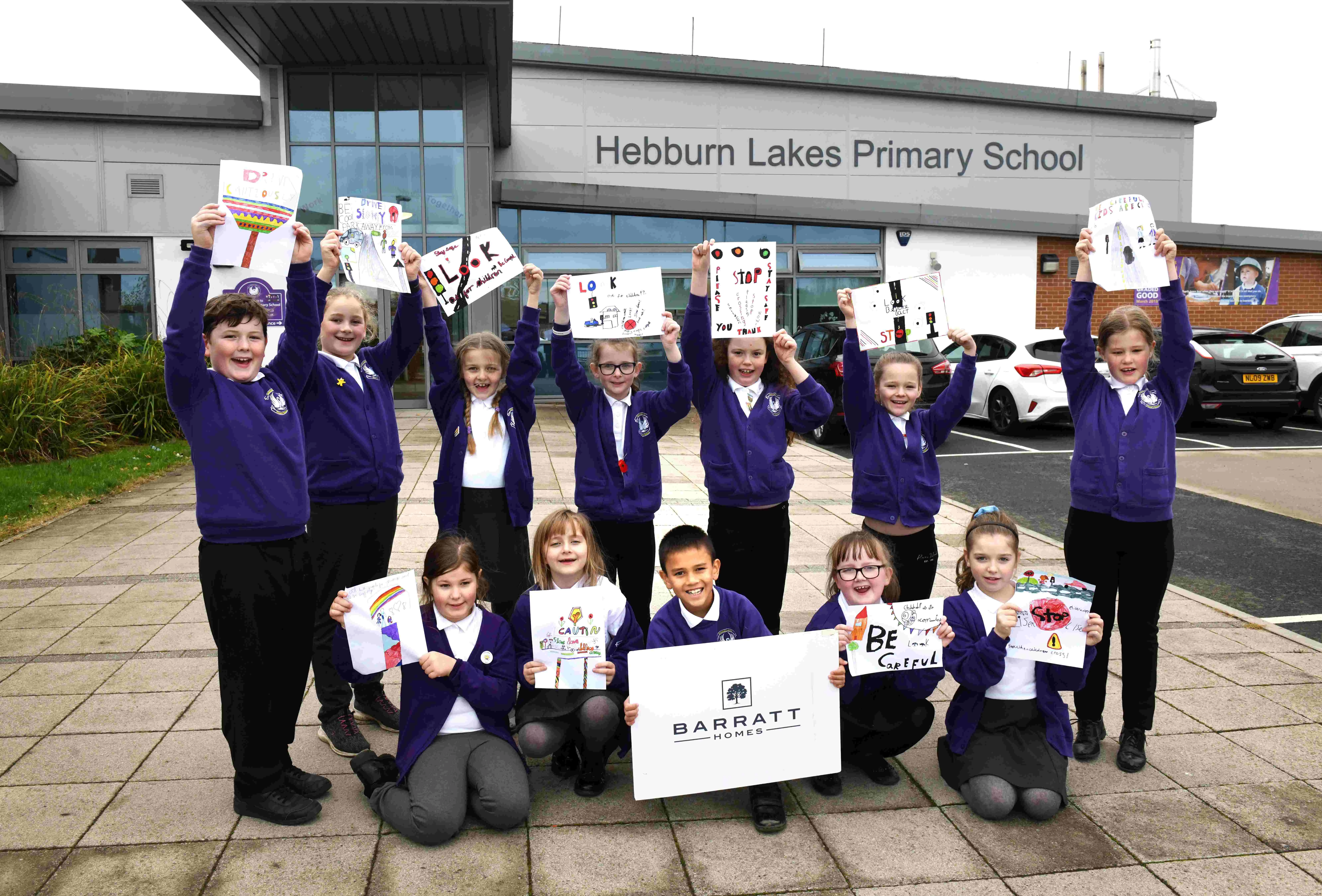 The students at Hebburn Lakes Primary School show off their road posters