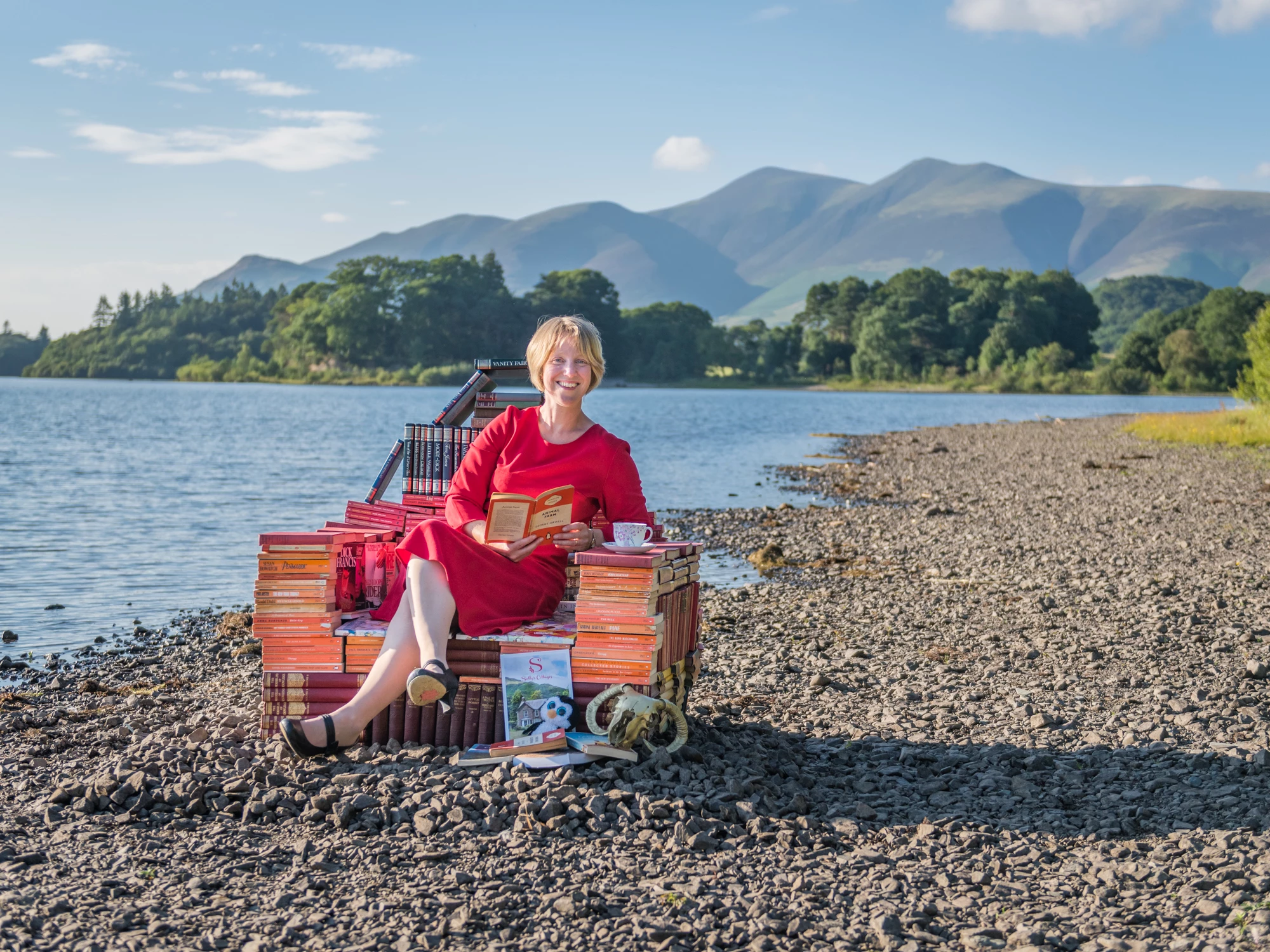 Sally Fielding, of Sally's Cottages, relaxes in a chair of books