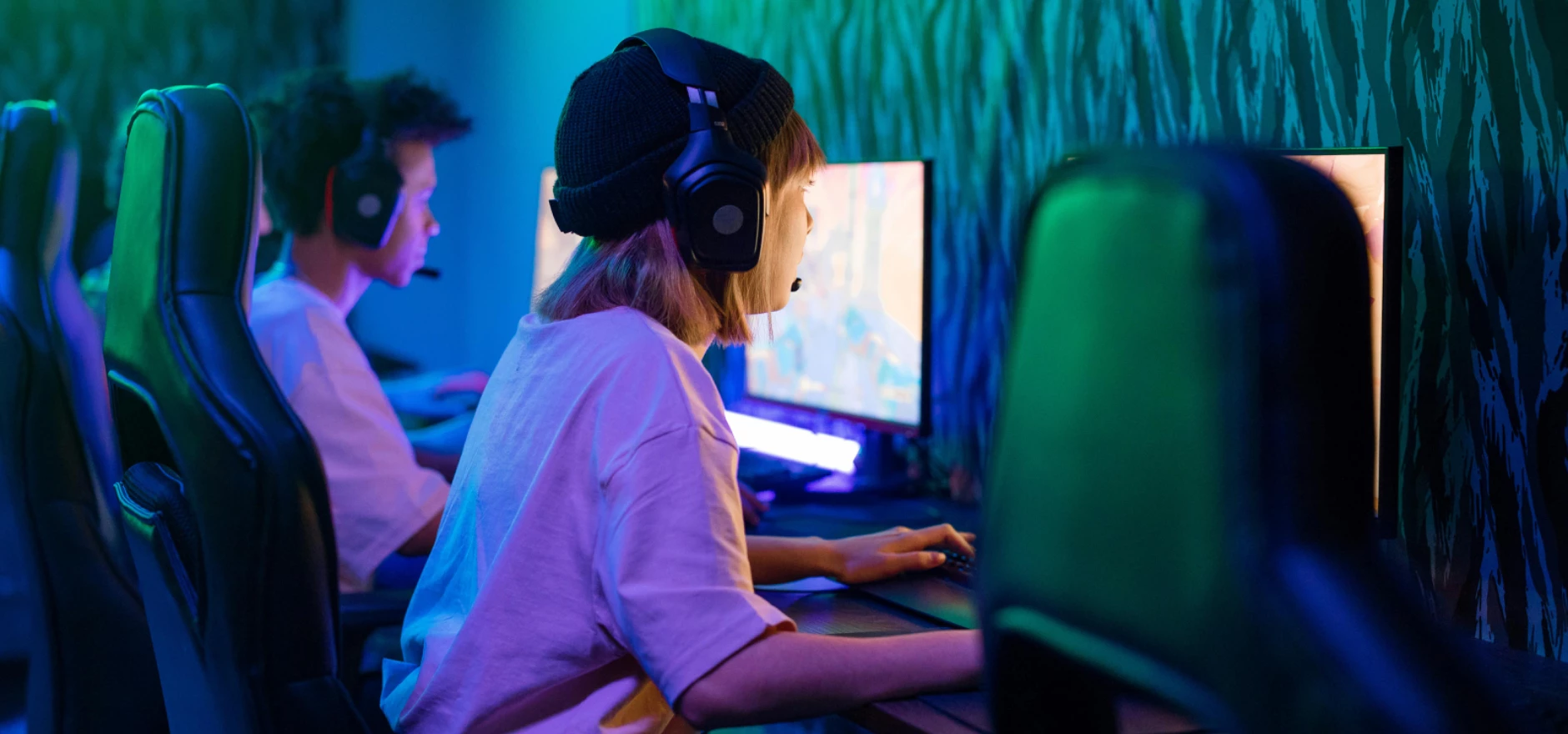 Young gamers deeply focused on an intense gaming session in a high-tech esports arena.