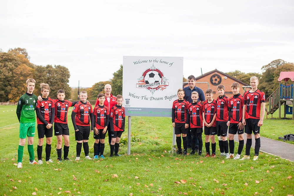 (Front) Heighington AFC under 14s, (Back L-R) Arthur Rudd, coach and Patrick Stephens, director of The Shred Centre.